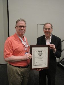 Dwayne Littauer congratulates Mark Schwartz, who won the Tracy Simpson Cup for Outstanding Service to the Society.